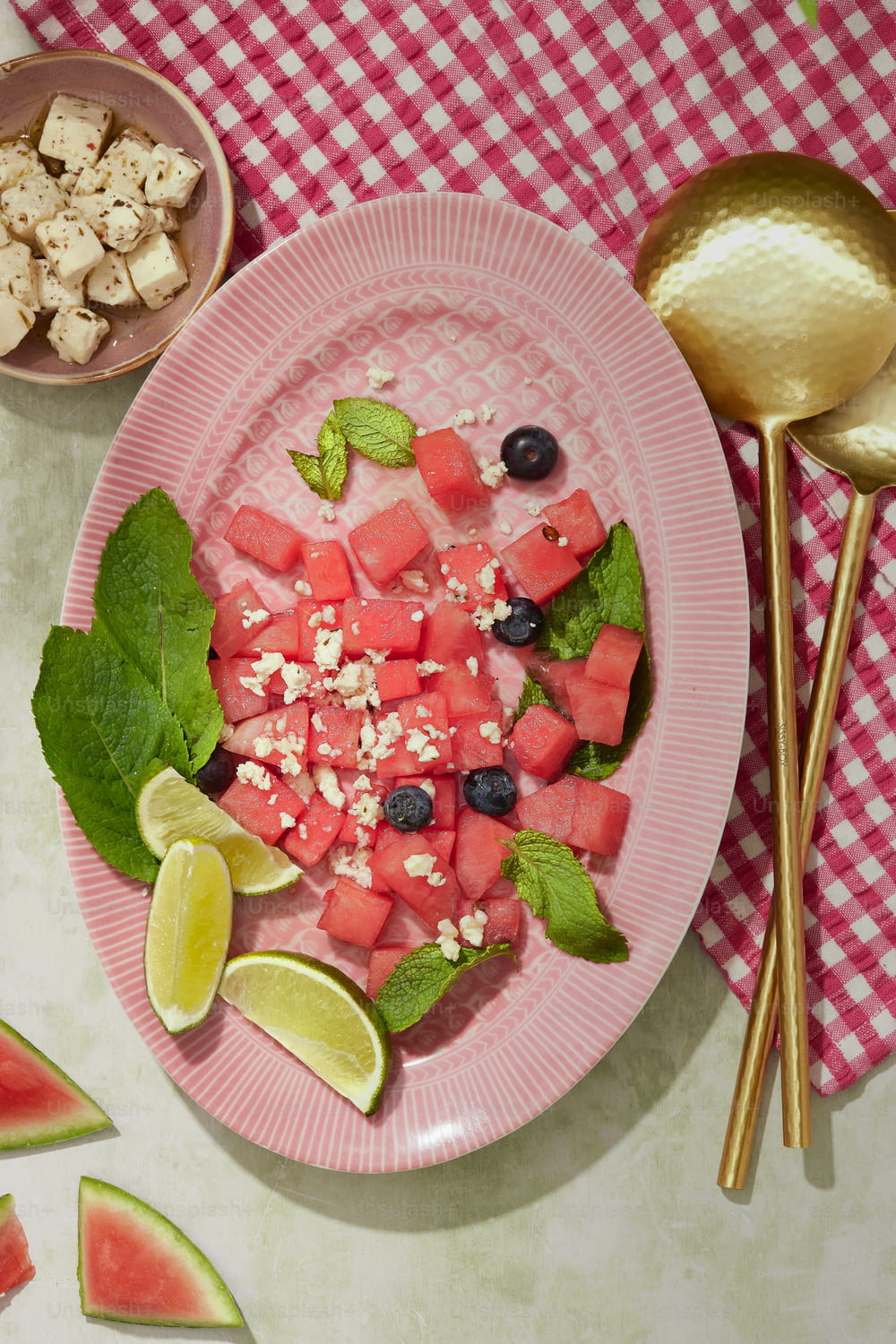 a plate of watermelon, cucumber, and mint salad