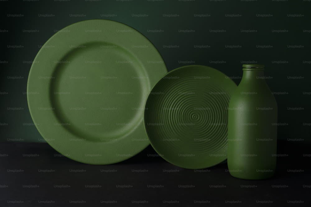a green plate and a green vase on a table