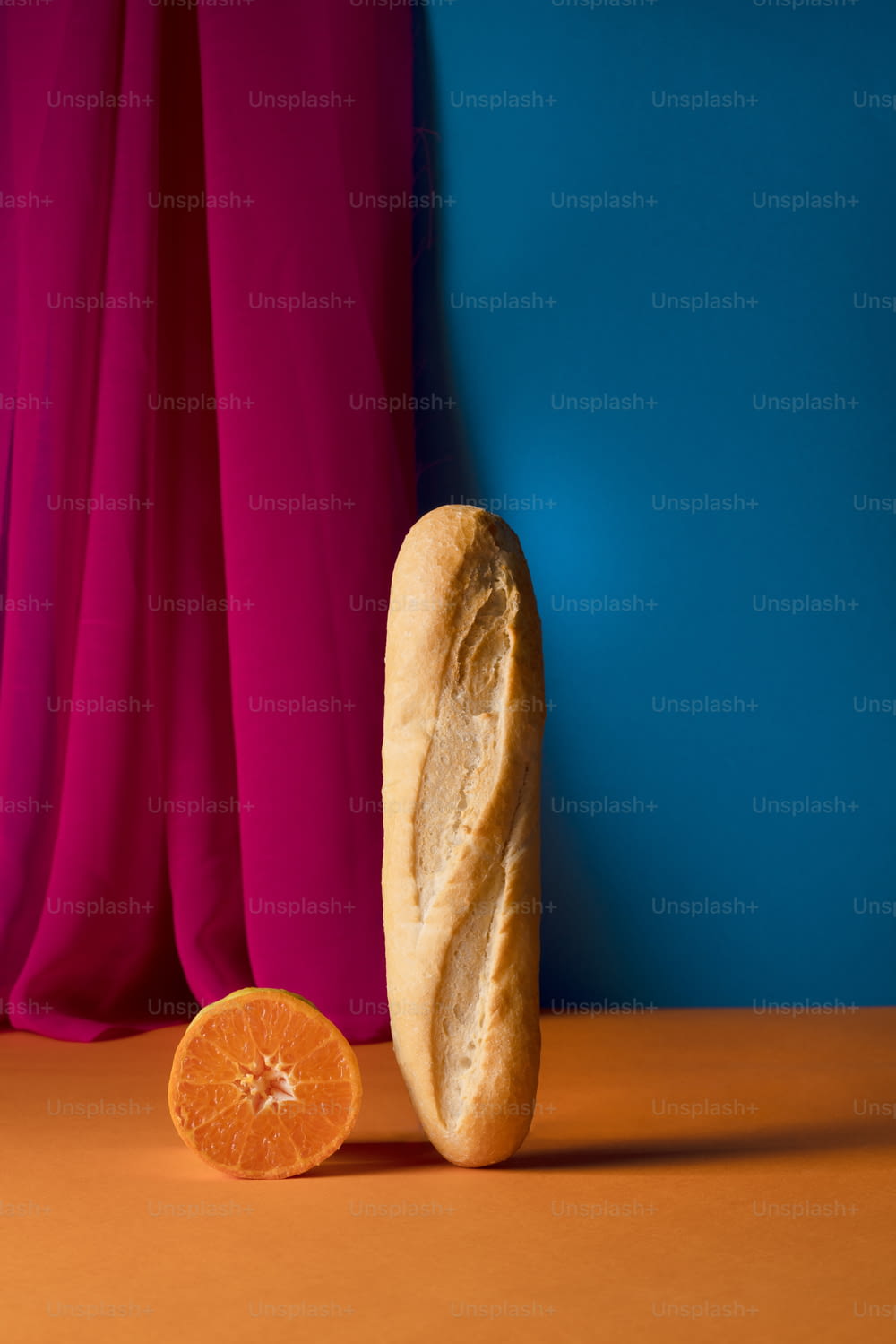 a loaf of bread sitting next to an orange slice