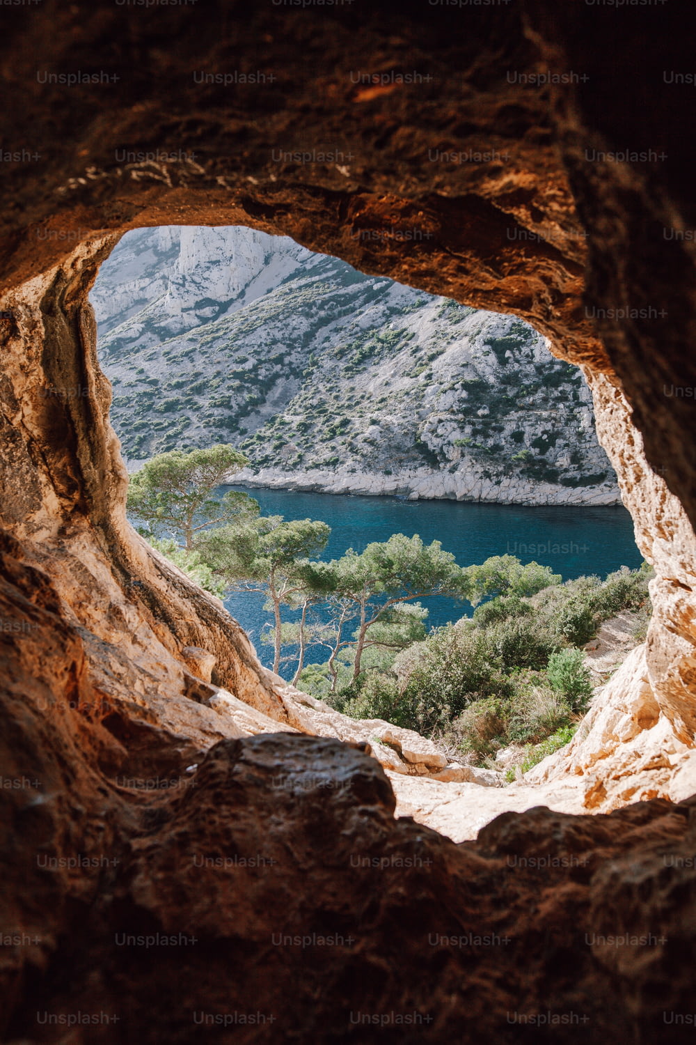 a view of a lake through a cave