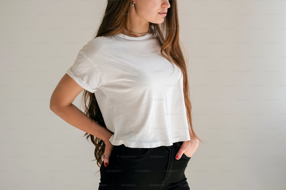 a woman wearing a white shirt and black pants