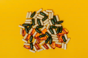 a pile of pills sitting on top of a yellow table