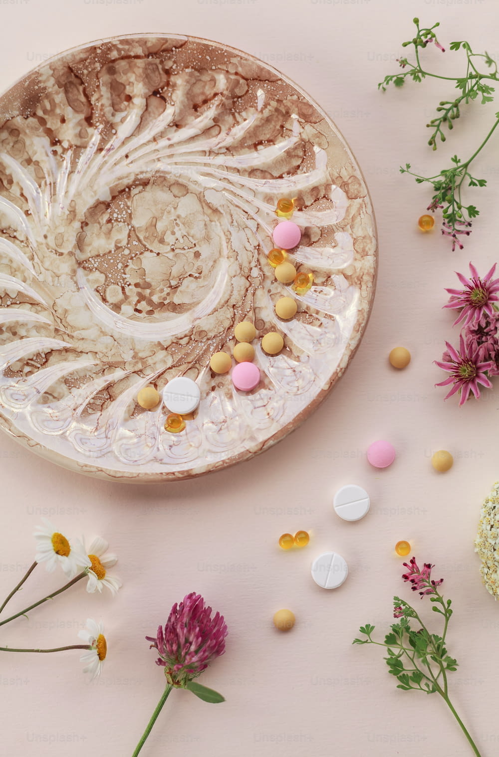 a plate with flowers and pills on it