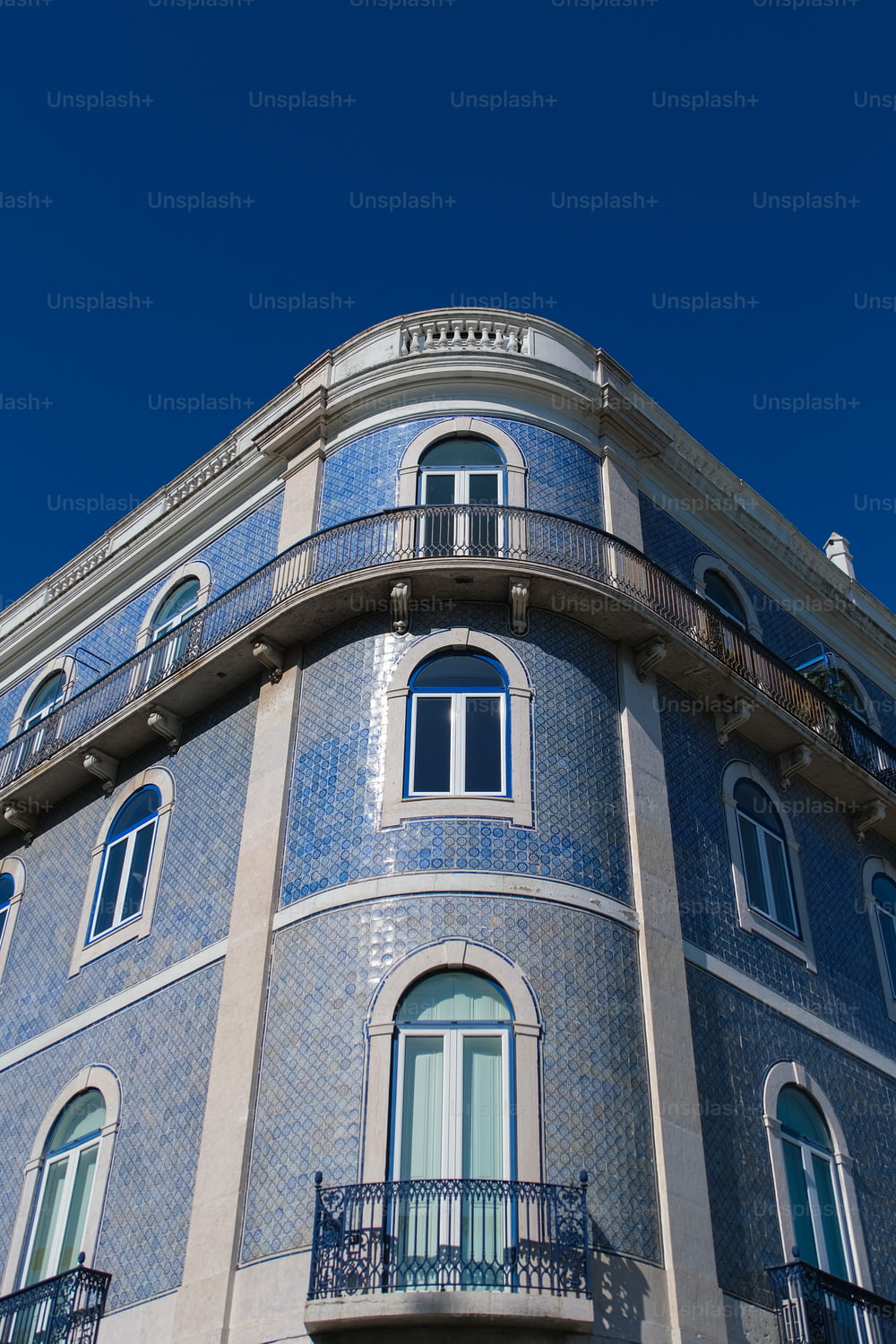 a blue building with a balcony and balconies