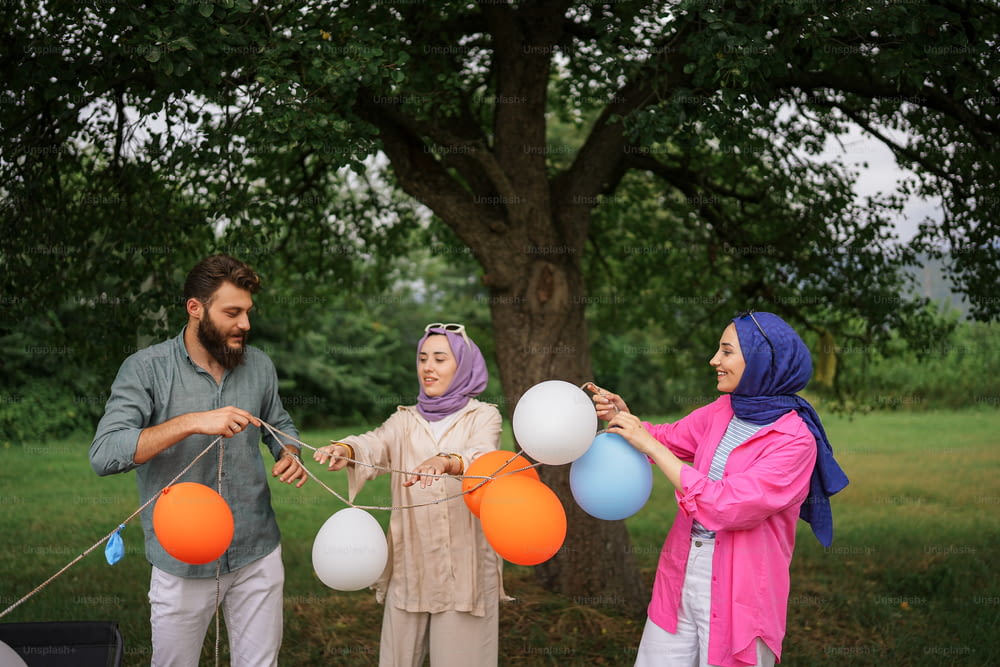 a group of people standing around each other holding balloons