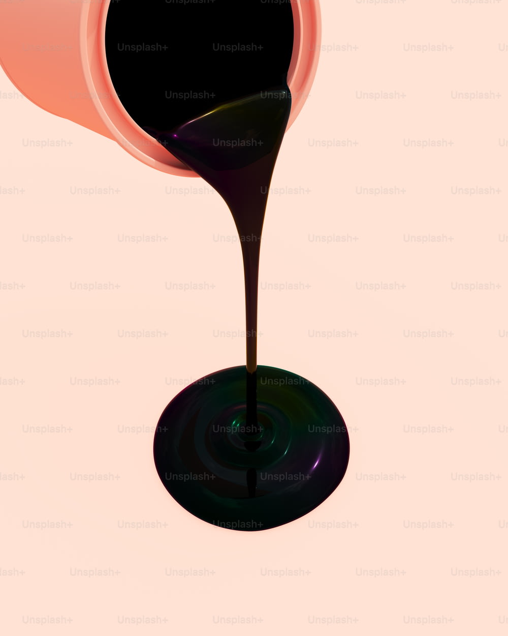 a black liquid pouring out of a pink cup