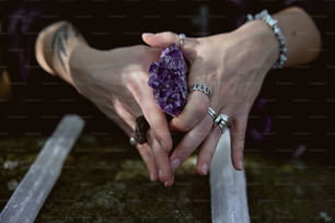 a person holding a purple rock in their hands
