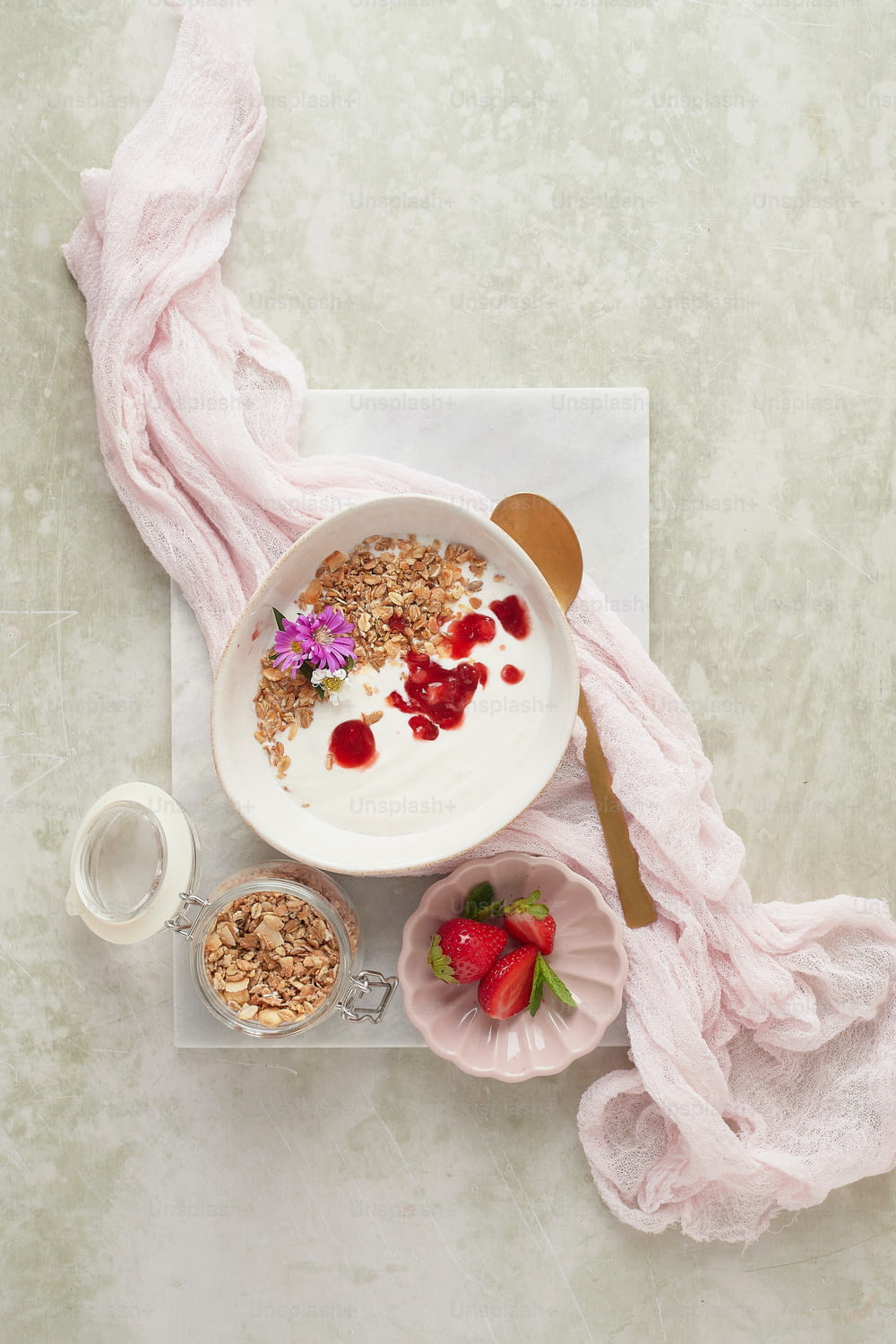 a bowl of yogurt with strawberries and granola