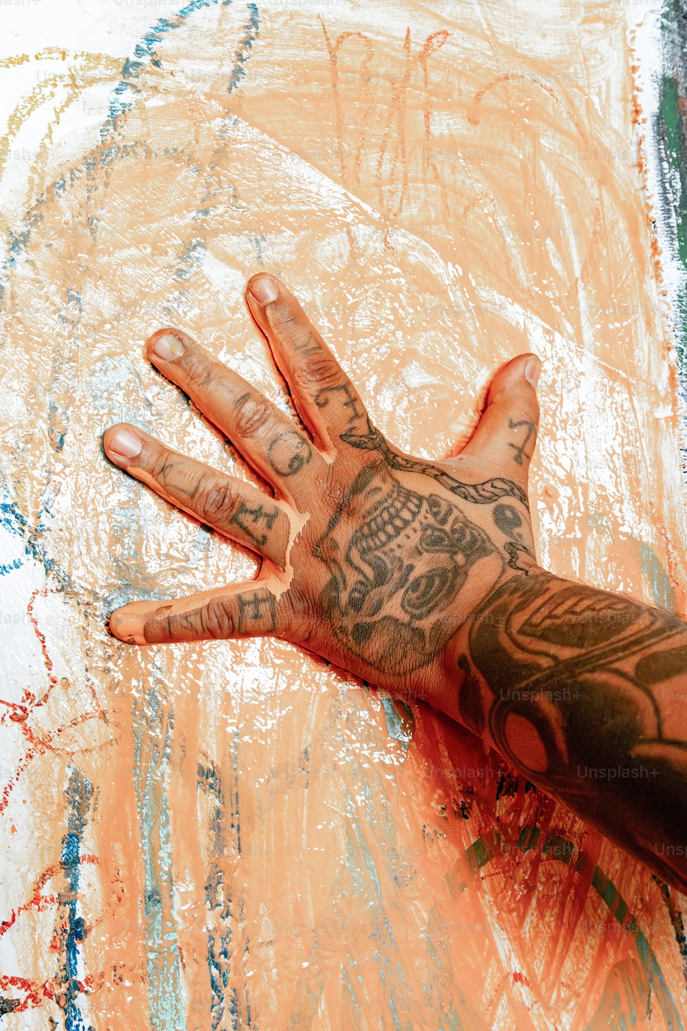 a person's hand with tattoos on it