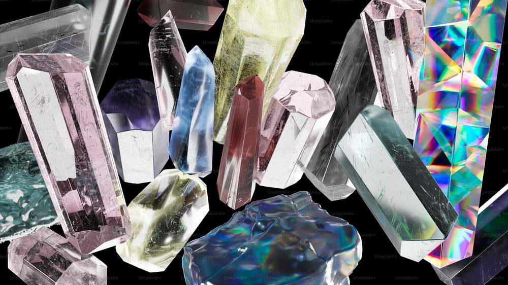 a group of different colored crystals on a black background