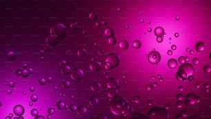 a bunch of water droplets on a purple and pink background