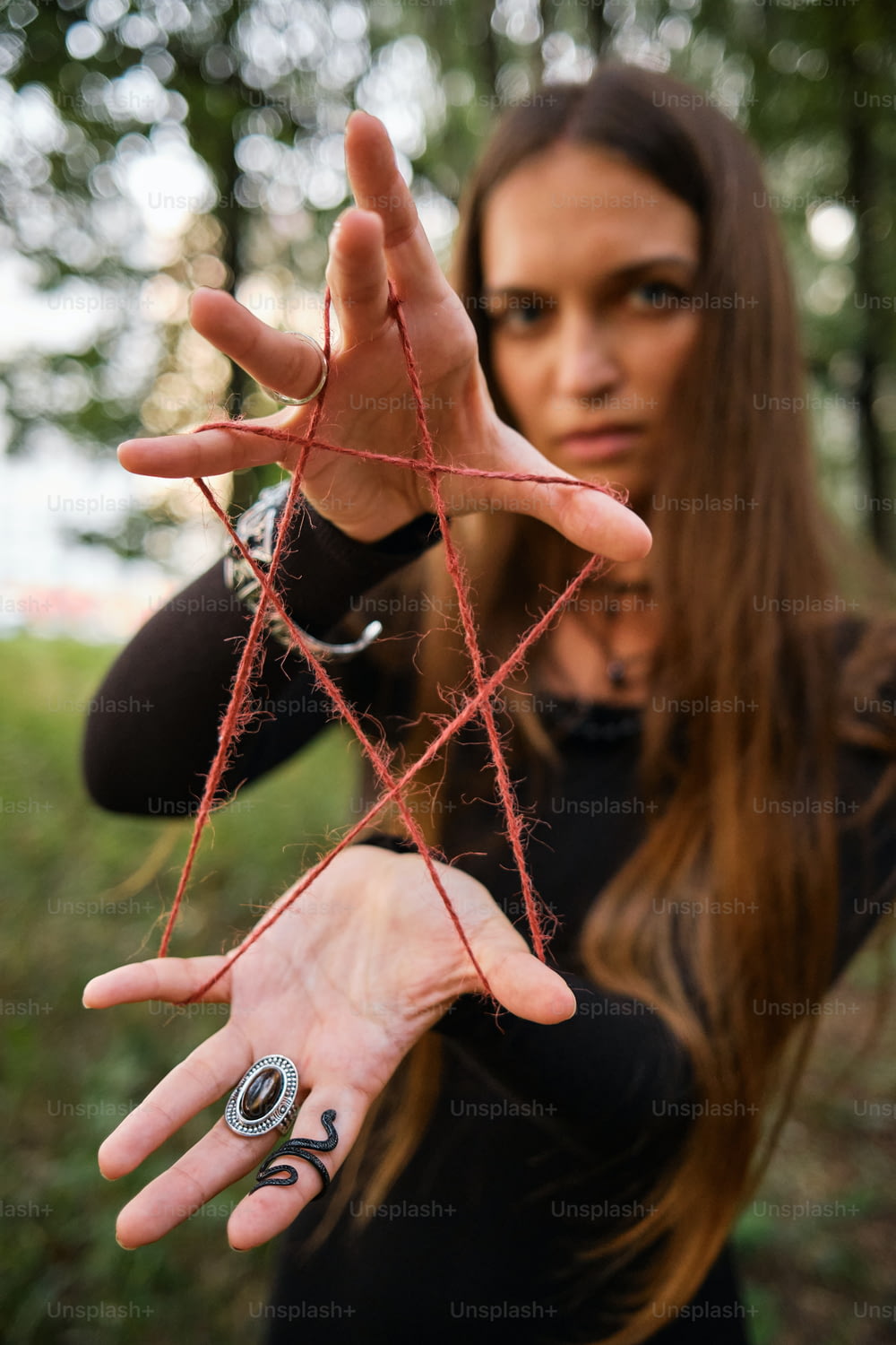 a woman holding out her hand with a spider web on it