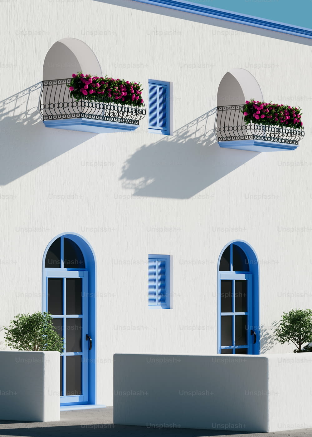 a white building with blue windows and a balcony