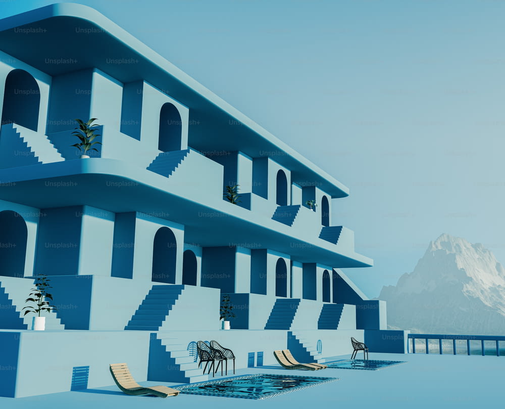 a blue and white building with a pool in front of it