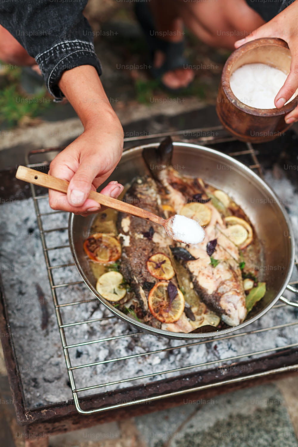 a person is cooking fish on a grill