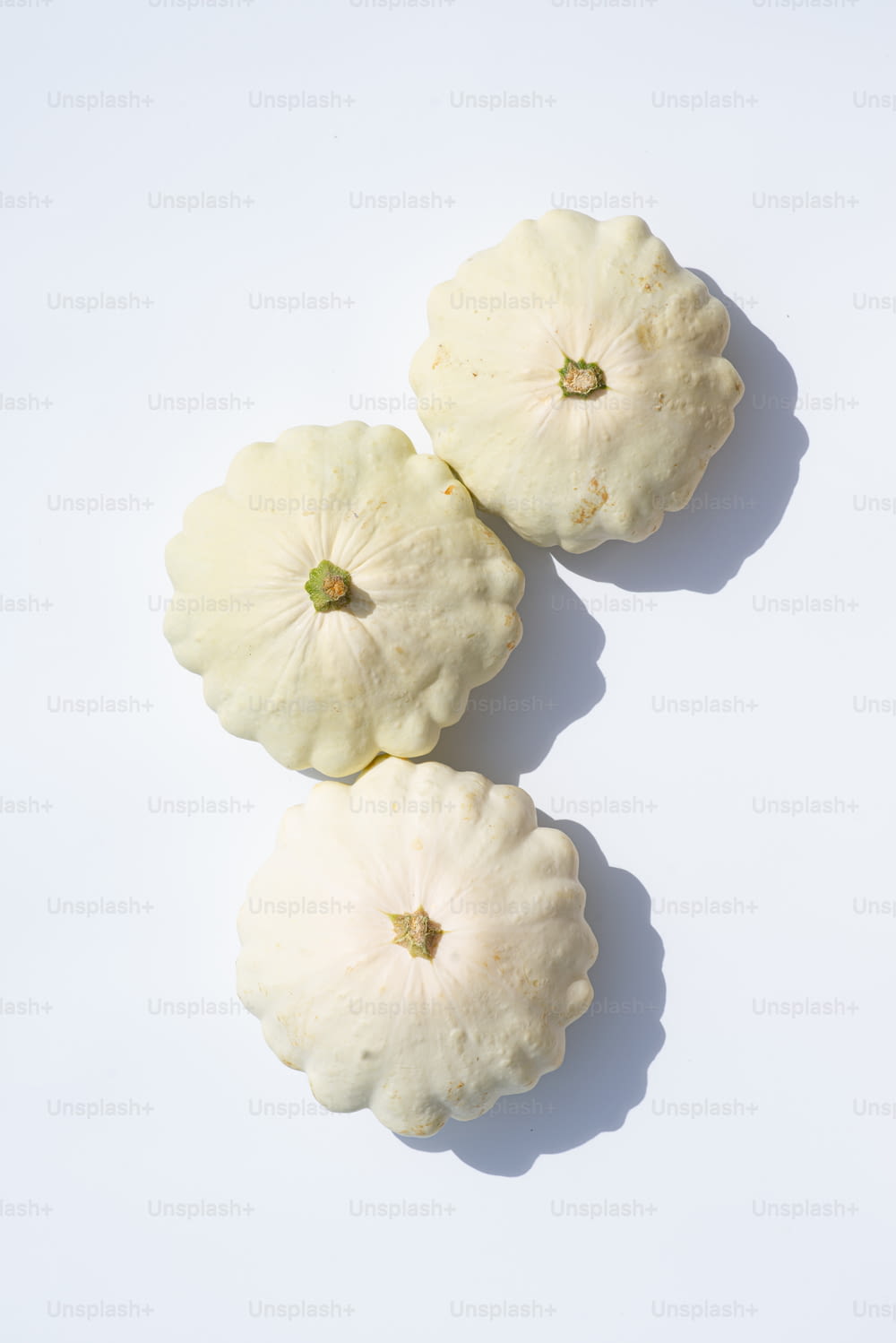 a couple of white pumpkins sitting on top of a table