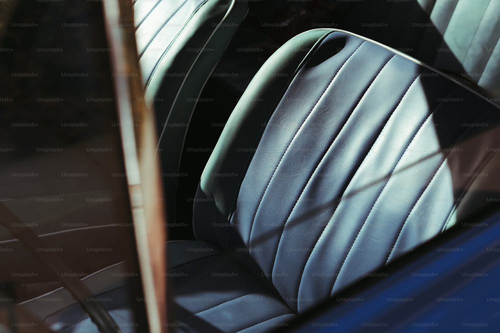 a close up of a car's seats with a mirror in the background