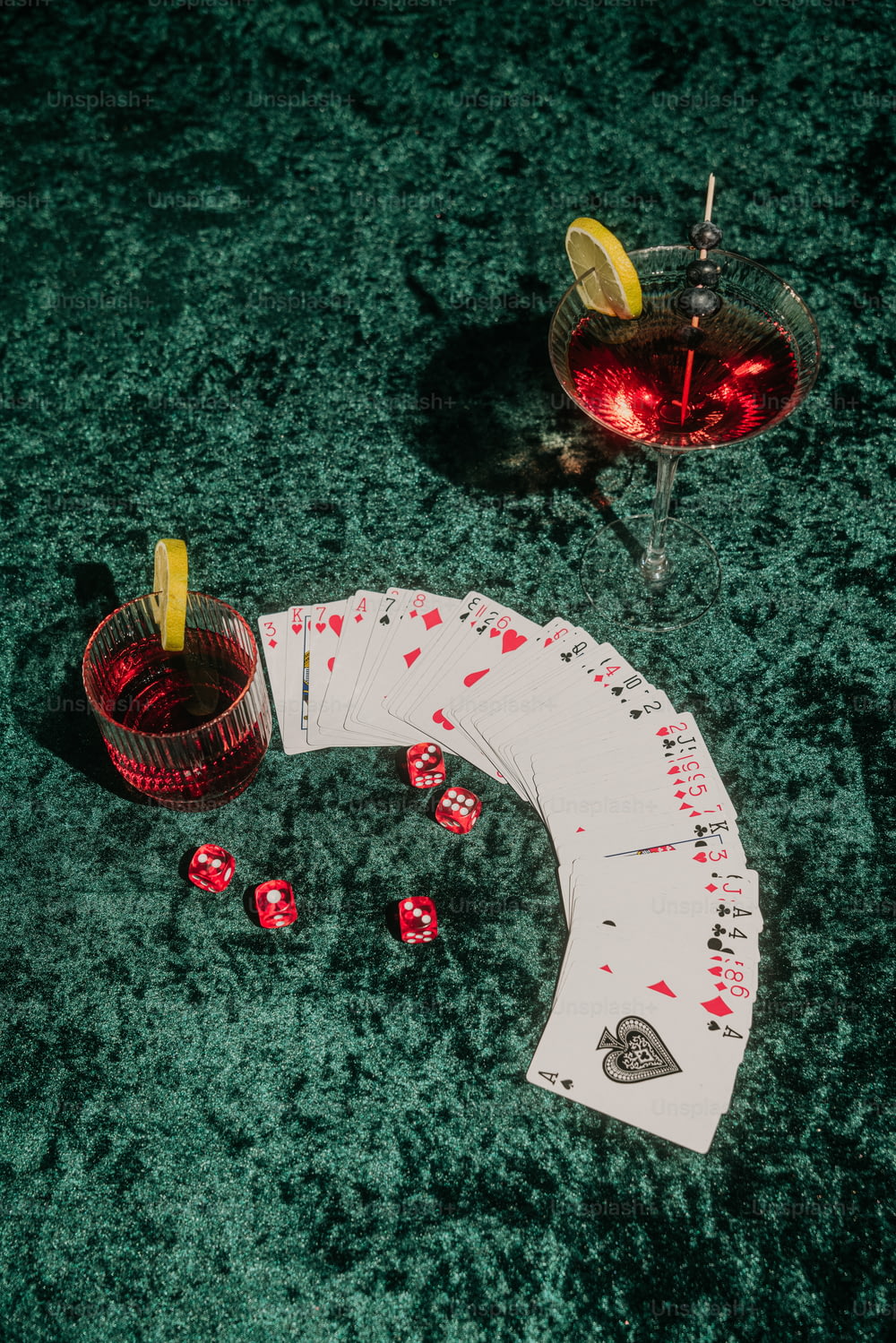 a table topped with cards and a drink