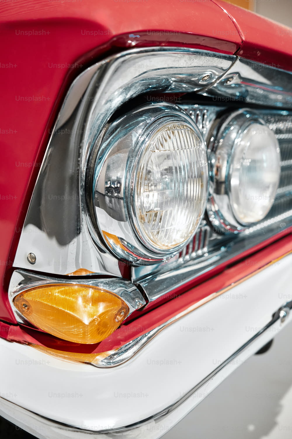 a close up of a red and white car headlight