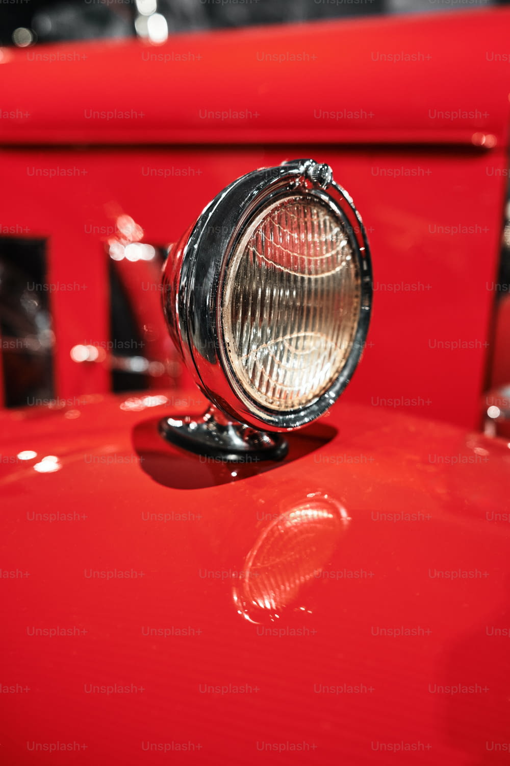 a close up of a light on a red car