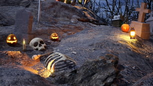 a cemetery with carved pumpkins and carved skeletons