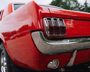 a close up of the tail end of a red mustang