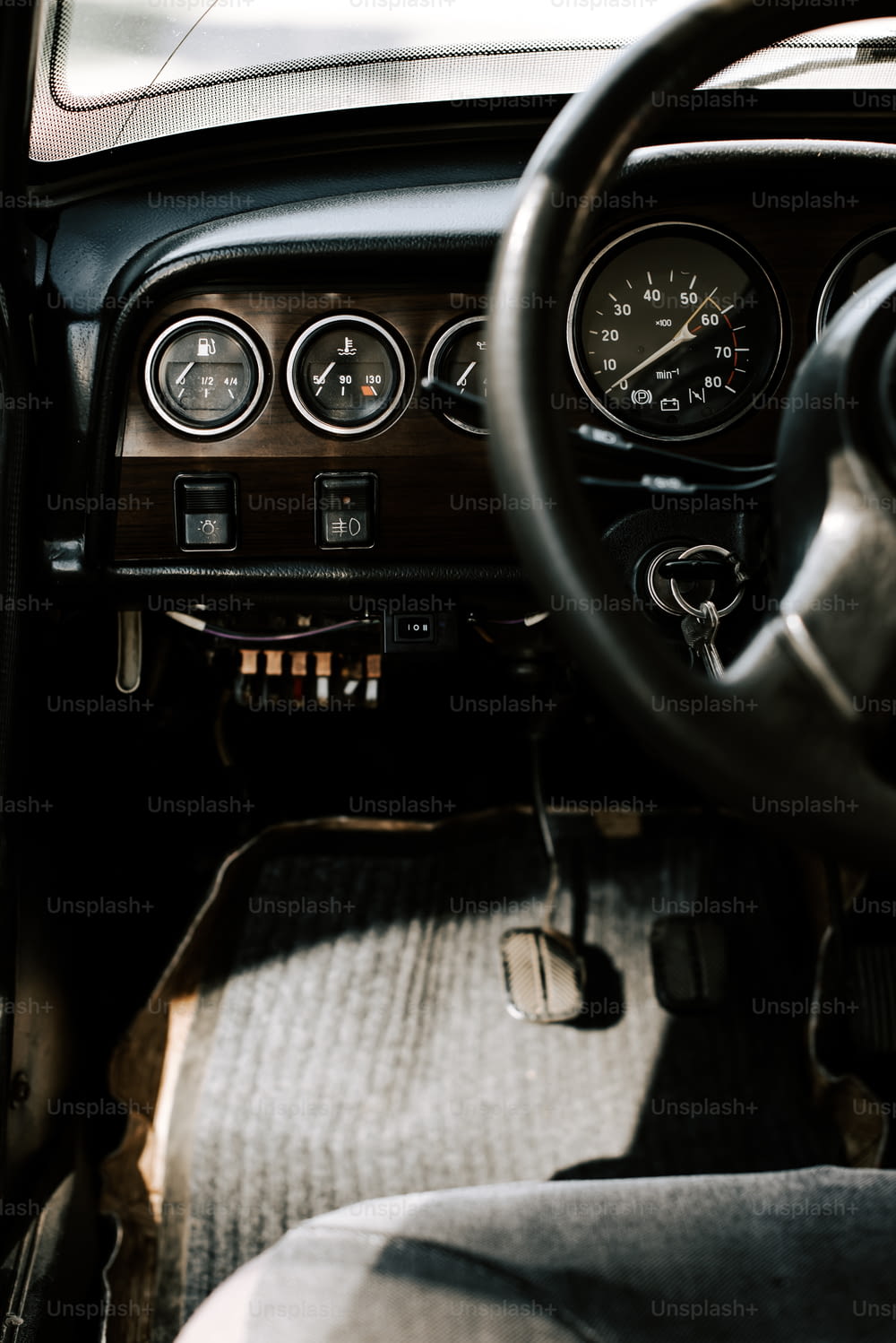 a dashboard of a car with a steering wheel