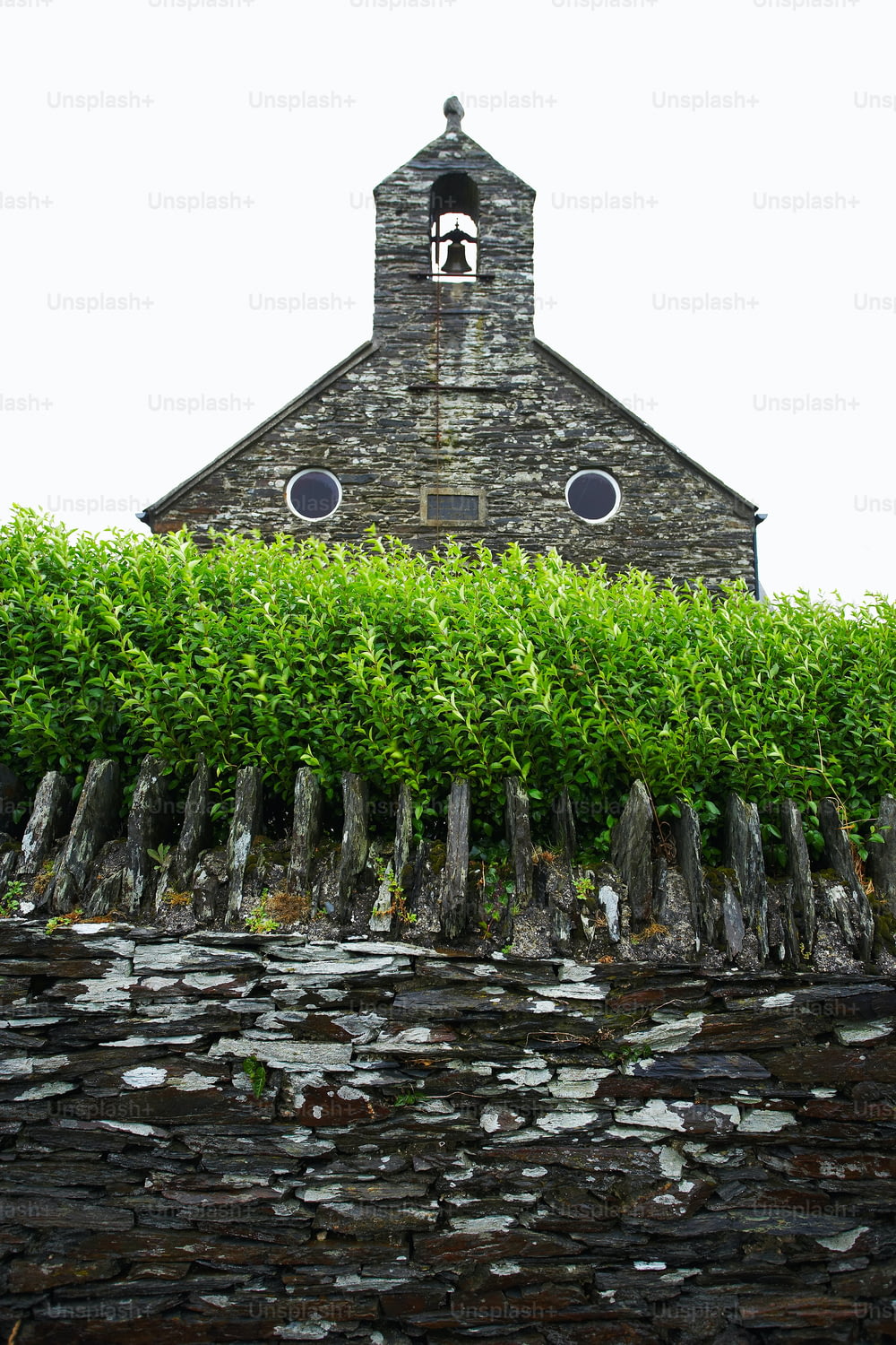 a stone building with a clock on the top of it