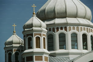 a large white building with a cross on top of it