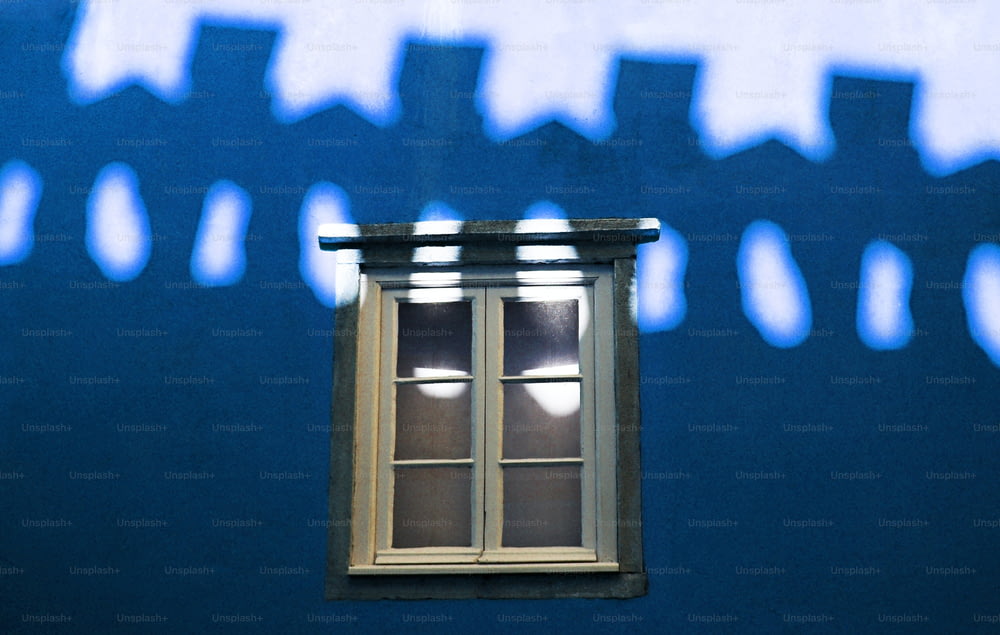 a shadow of a window on a blue wall