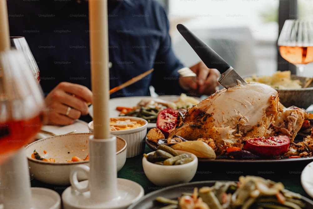 a person is cutting a turkey on a plate