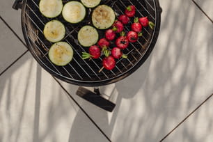 a grill with strawberries, cucumbers and strawberries on it