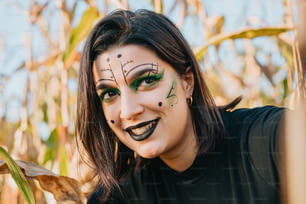 a woman with makeup on her face posing for a picture