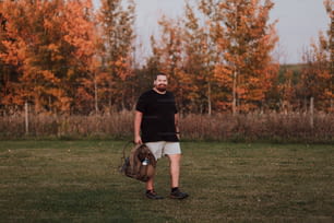 a man standing in a field with a catchers mitt