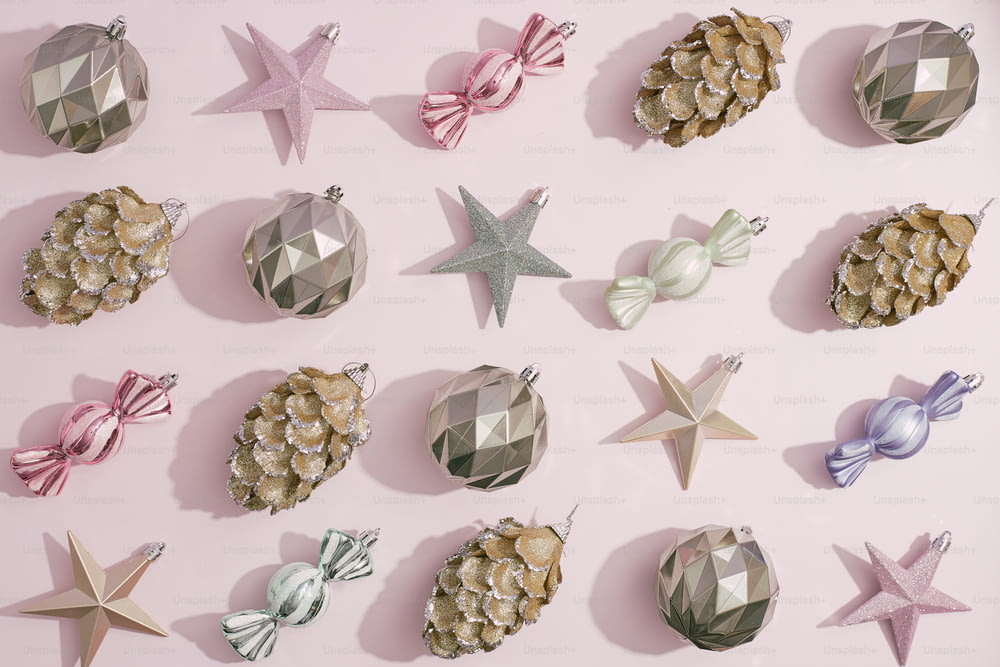 a collection of christmas ornaments on a pink background