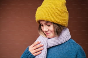 a woman wearing a yellow hat and scarf