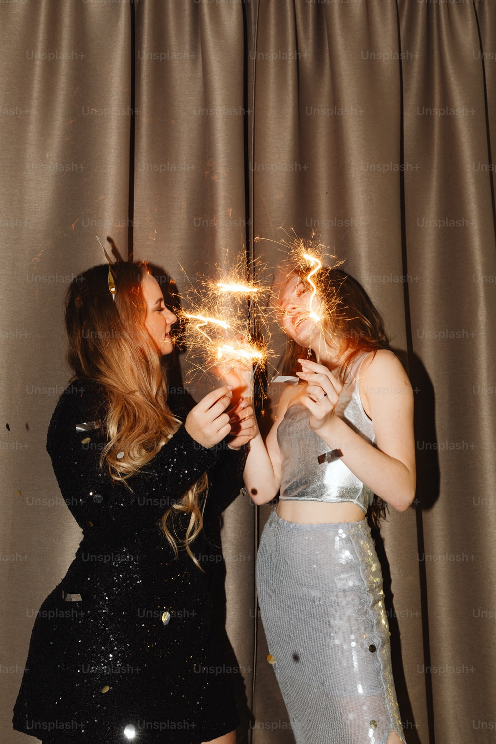 two women are holding sparklers in their hands