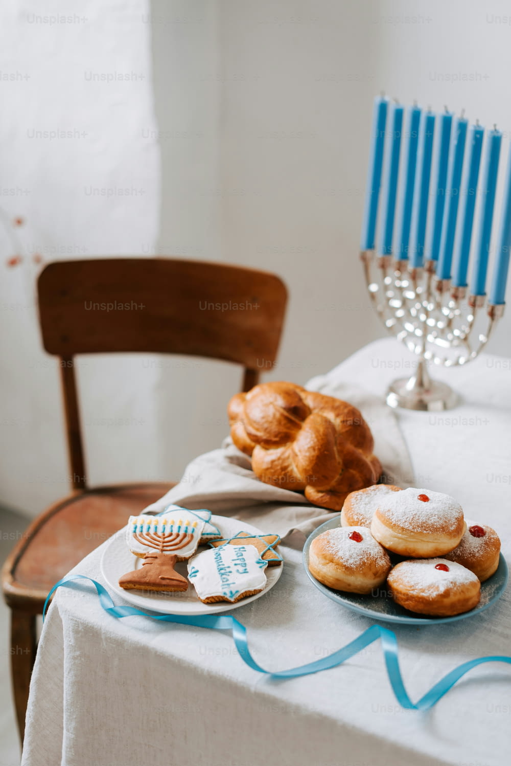 a table topped with pastries and a plate of donuts