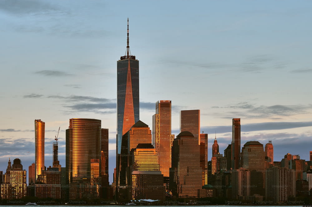 The New York City skyline at Manhattan downtown viewed from across Hudson River at sunset, USA