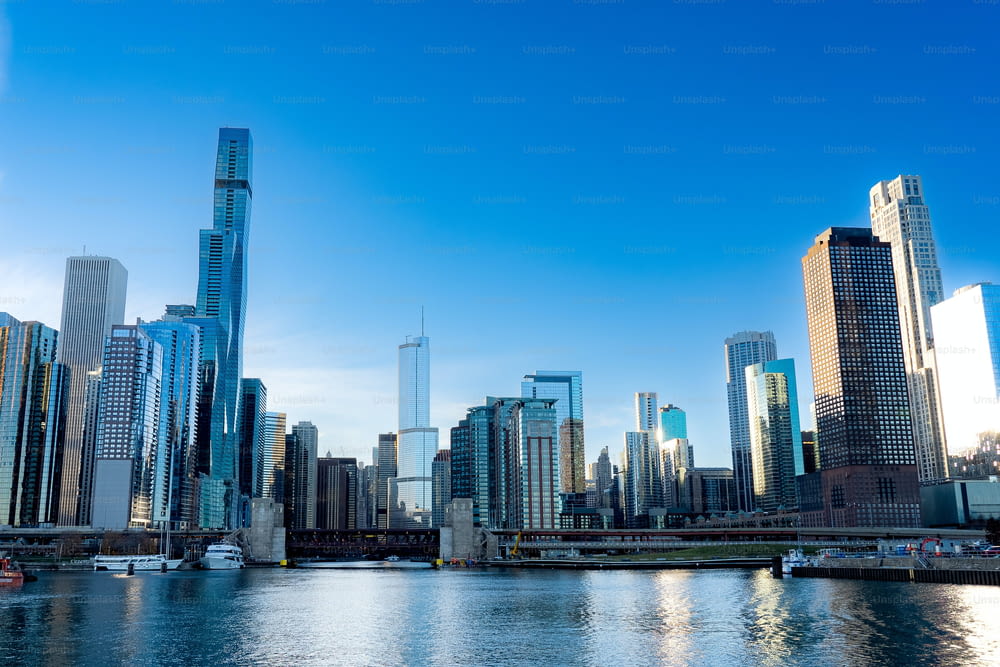 The cityscape of Chicago with the lake in the foreground and a clear blue sky in the background.