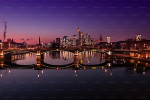 Frankfurt skyline in the blue hour. building illuminated. In the foreground the raft bridge.