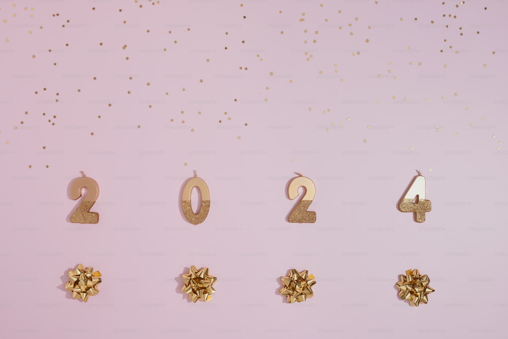 a pink background with gold numbers and bows