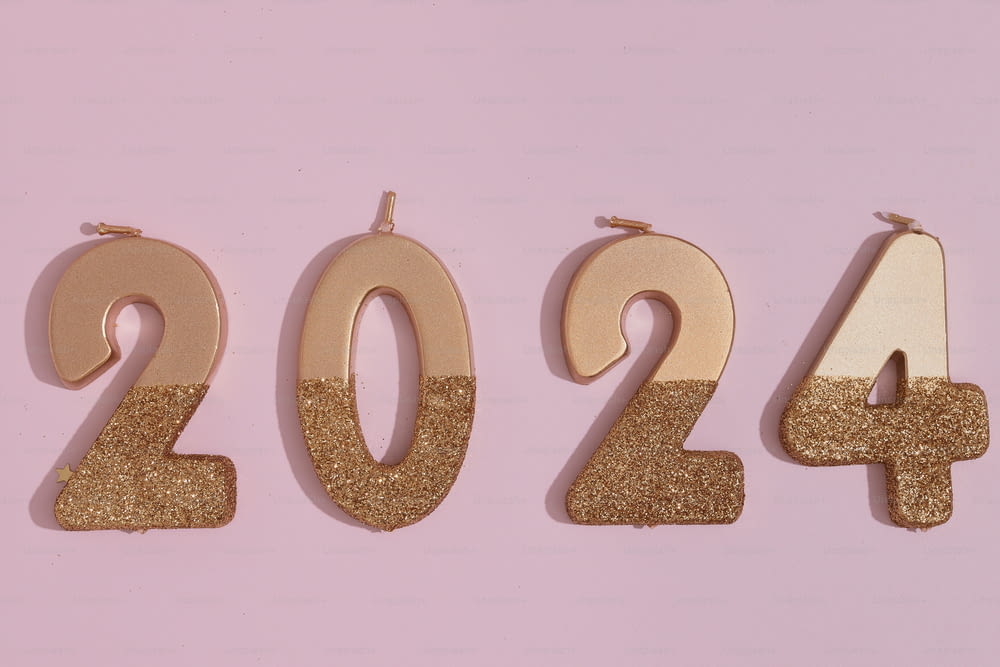 a number of gold numbers on a pink background