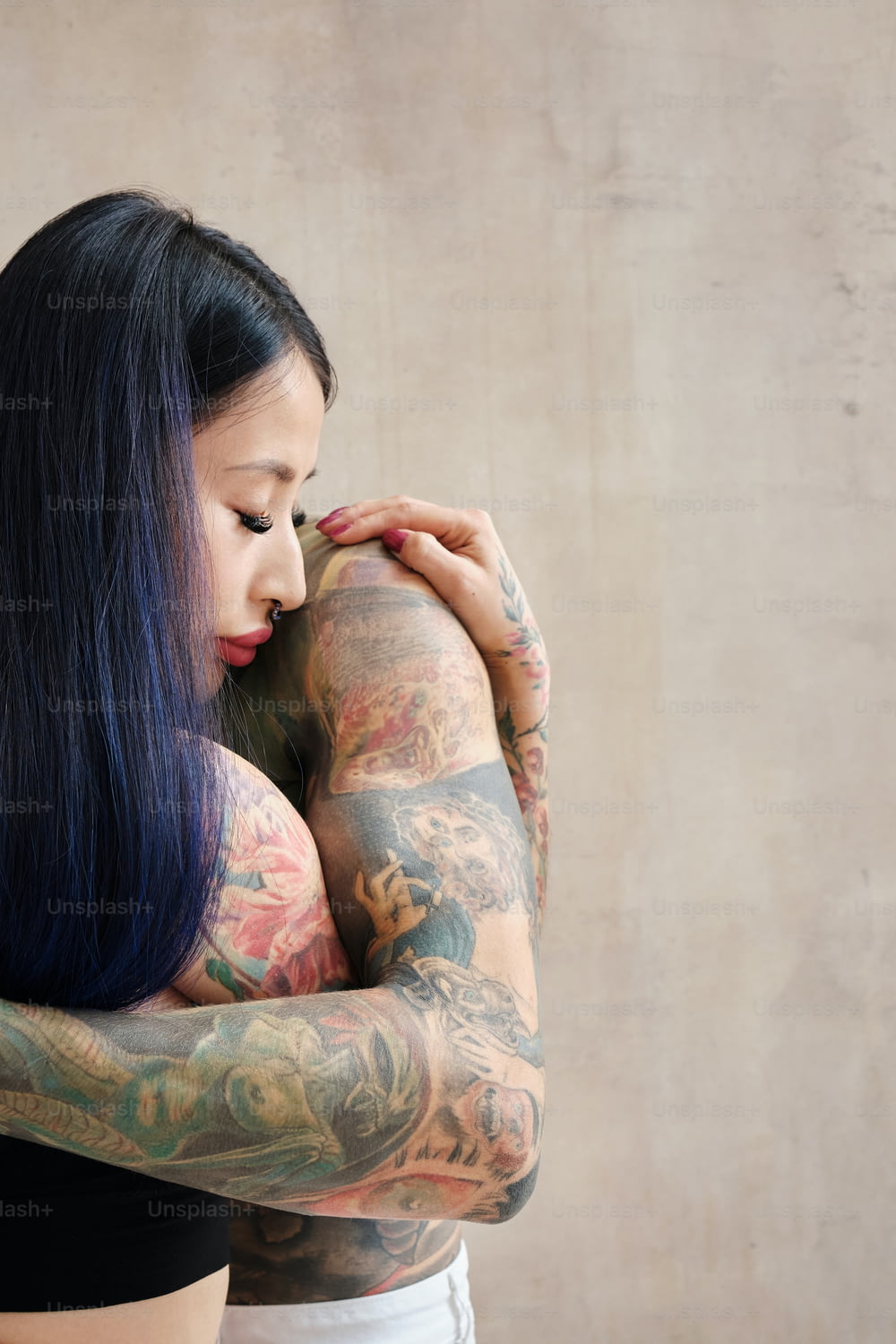 a woman with a lot of tattoos on her arms