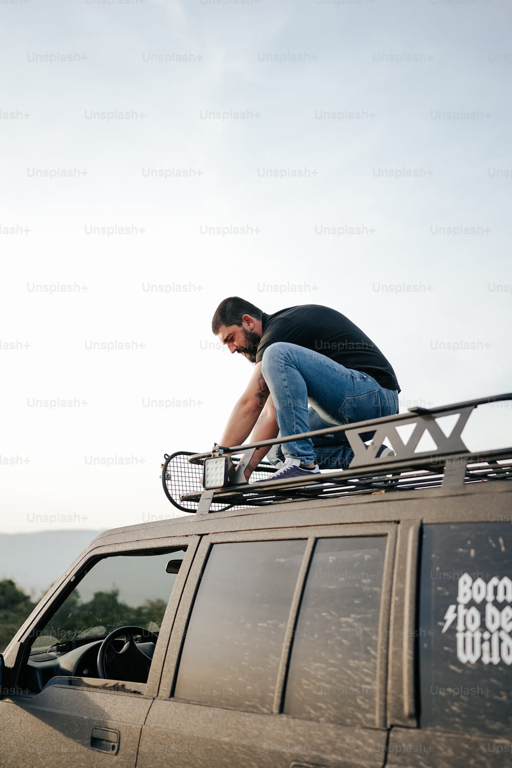 a man sitting on top of a vehicle