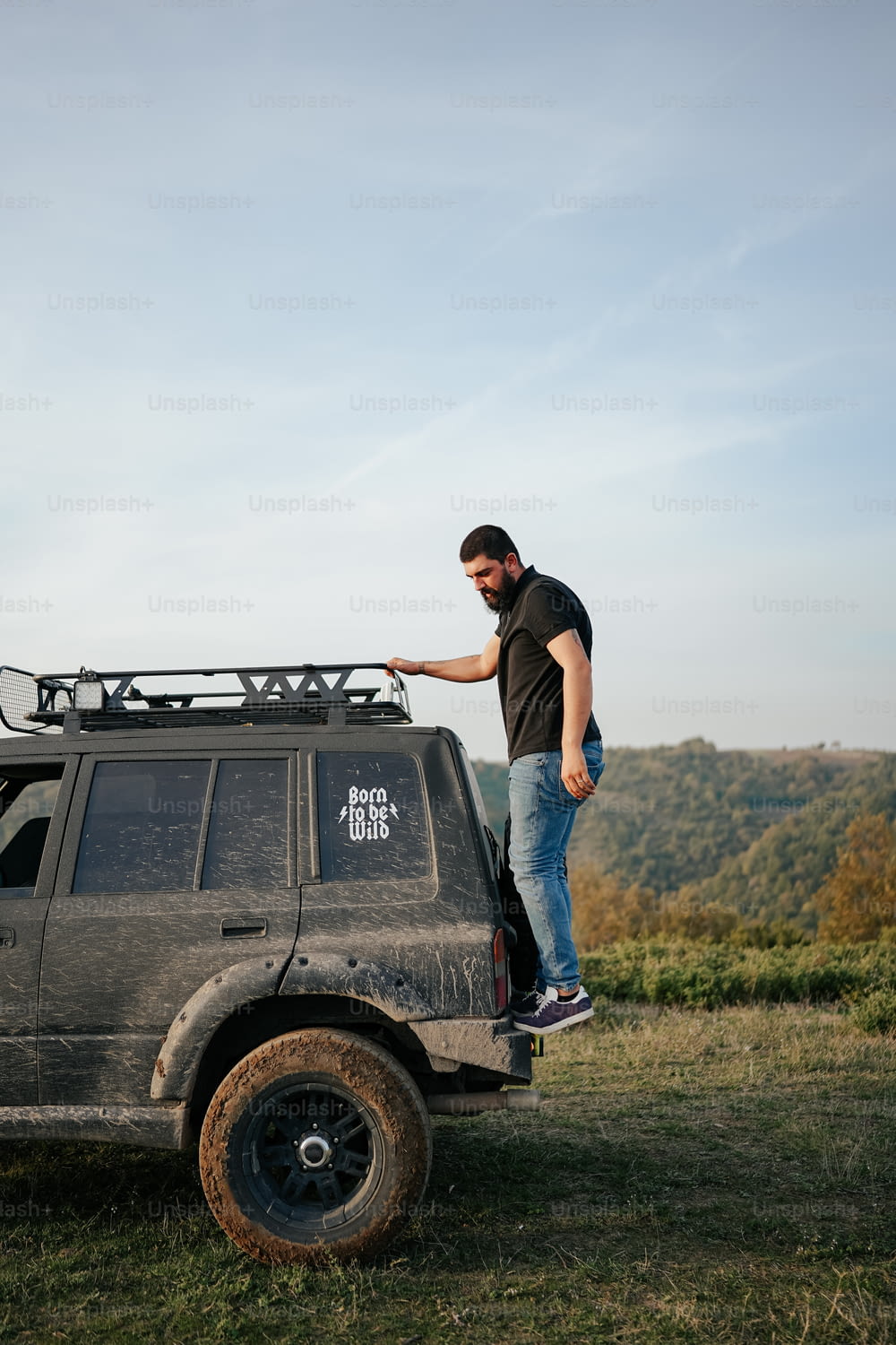 a man standing on top of a vehicle