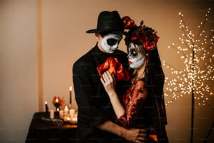 a man and woman dressed up in skeleton makeup