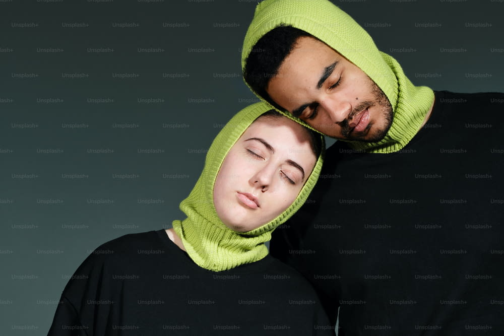 a man and a woman with a hood on their heads