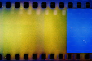 a close up of a film strip with blue and yellow squares