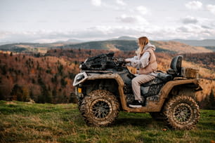 a woman riding on the back of an atv
